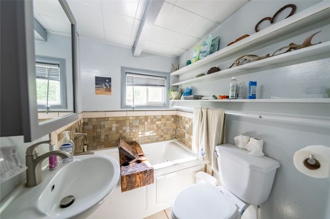 Bathroom featuring healthy amount of natural light, a bath, and beam ceiling | Image 7