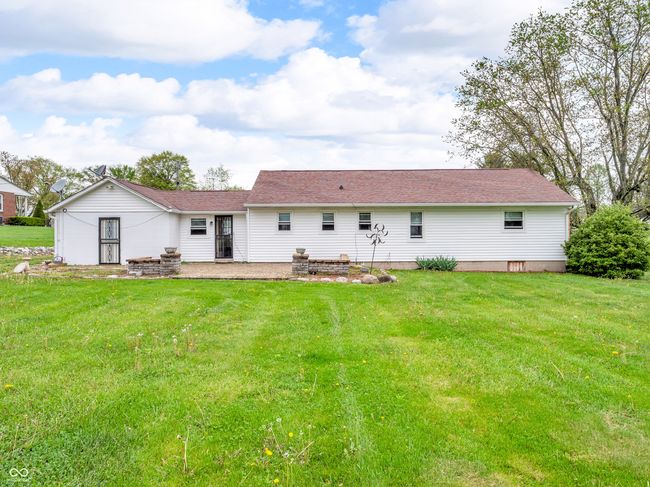 back of house with a shingled roof, a yard, and a patio area | Image 6