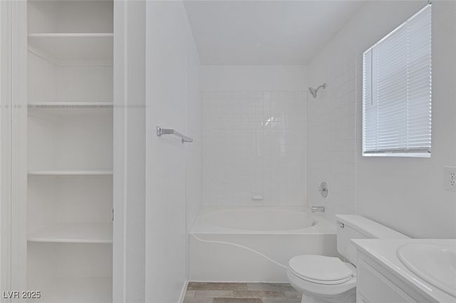 Bathroom with shower / washtub combination, vanity, and a closet | Image 19