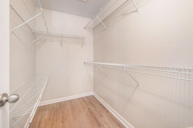 Walk in closet featuring wood finished floors | Image 22