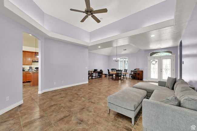 Living room featuring french doors, recessed lighting, baseboards, ceiling fan with notable chandelier, and arched walkways | Image 14