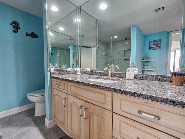 Bathroom with a marble finish shower and vanity | Image 25
