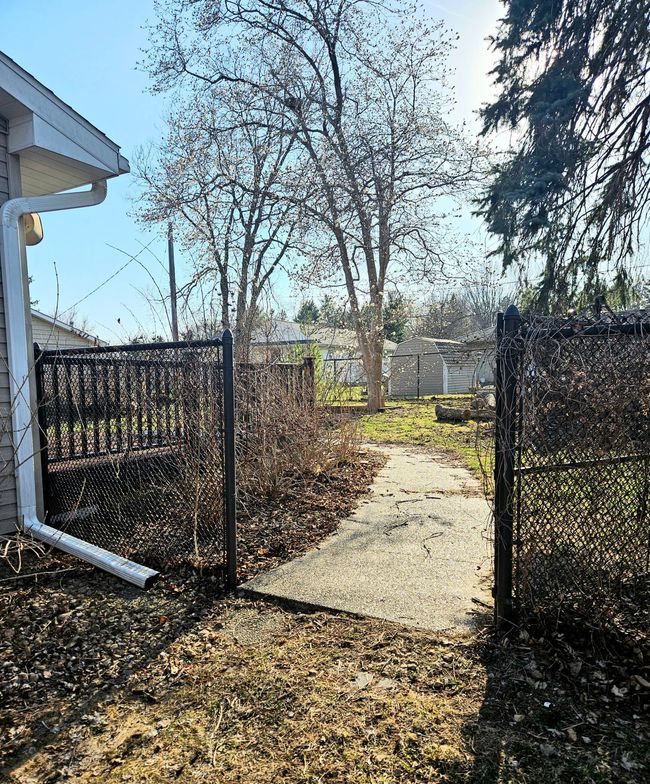 Gate to the Back Yard w/Aggregate Concrete Paths | Image 26