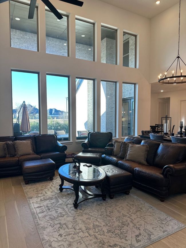 Living area featuring wood finished floors, a high ceiling, a chandelier, a mountain view, and recessed lighting | Image 10