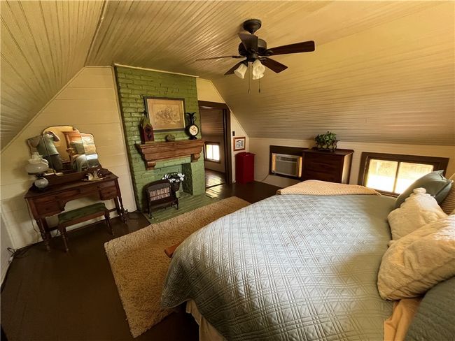 Bedroom with wooden ceiling, wood finished floors, and vaulted ceiling | Image 30