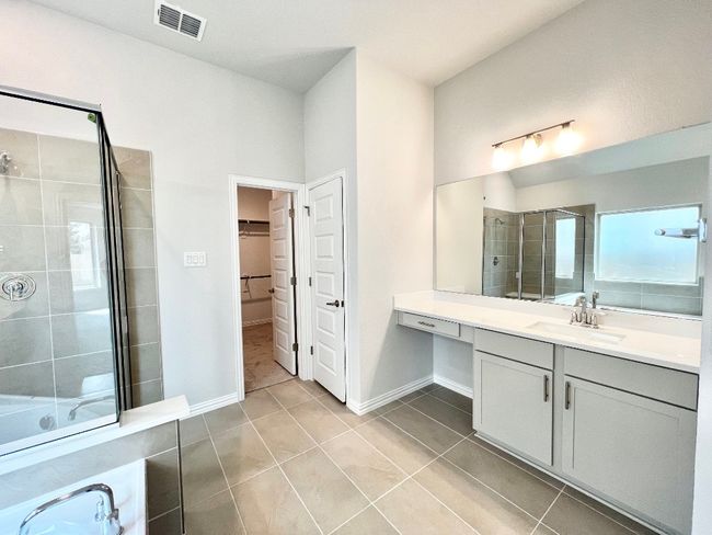 Full bathroom with a stall shower, a spacious closet, vanity, and light tile patterned floors | Image 14
