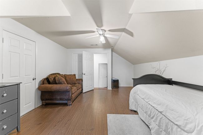 5th Bedroom with wood finished floors, lofted ceiling, and ceiling fan | Image 26