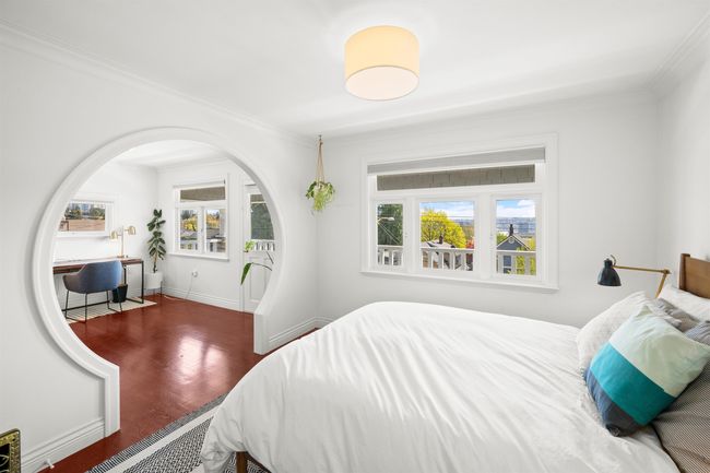 Bedroom with wood finished floors, crown molding, and multiple windows | Image 23