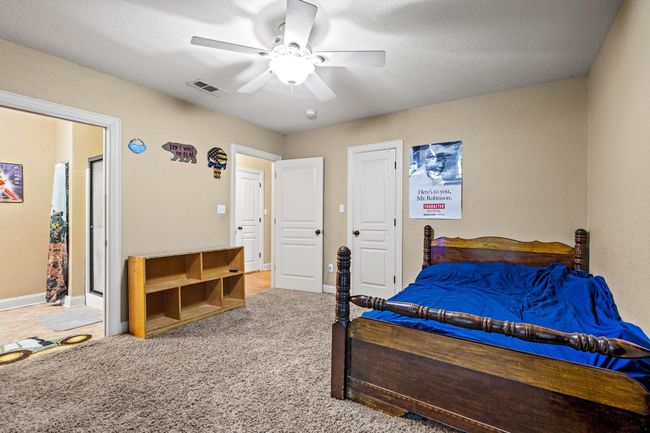 Bedroom featuring visible vents, carpet flooring, baseboards, and a ceiling fan | Image 28