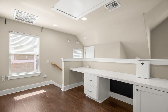 Unfurnished office with visible vents, baseboards, lofted ceiling, recessed lighting, and dark wood-style floors | Image 18