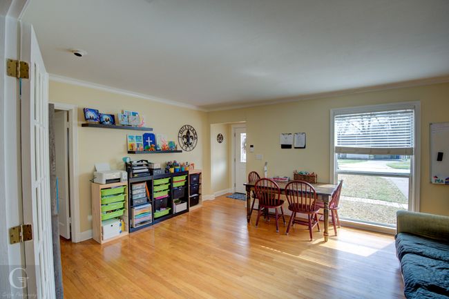 Dining area featuring ornamental molding, light wood-style flooring, and baseboards | Image 16