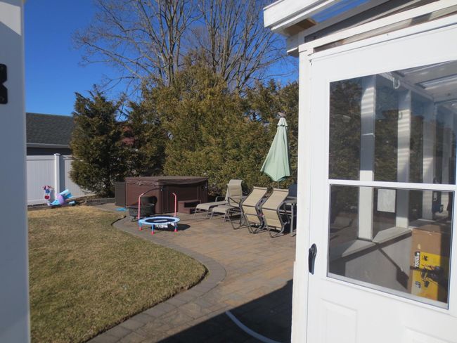 View of patio / terrace with a hot tub and fence | Image 8