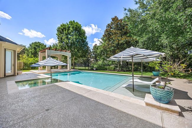 Beautiful resort-style pool with wrought iron fencing and no back neighbors. | Image 43