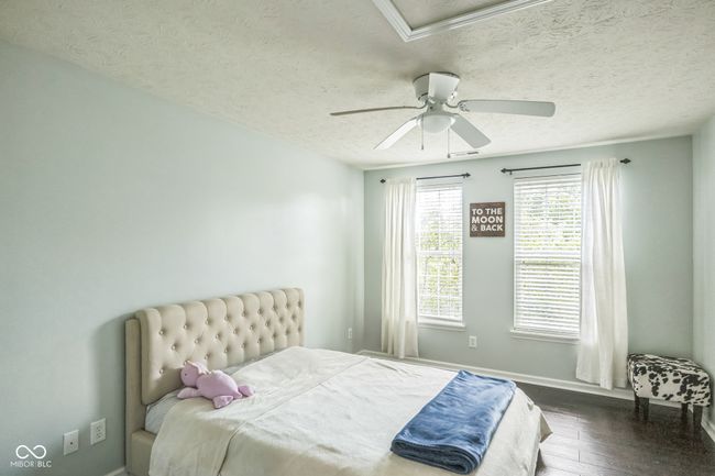 bedroom featuring a textured ceiling, hardwood / wood-style floors, and ceiling fan | Image 22