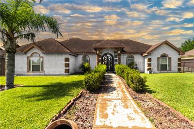 Ranch-style home featuring a lawn | Image 2