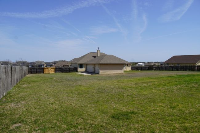 View of yard featuring a gate and a fenced backyard | Image 24