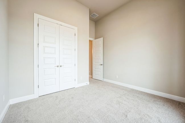 Unfurnished bedroom with a closet, visible vents, light carpet, and baseboards | Image 21