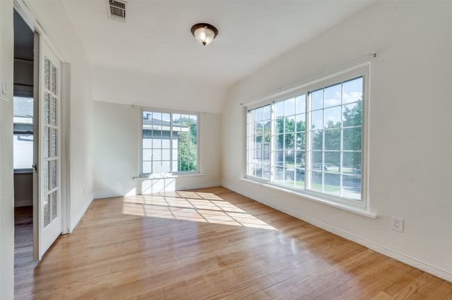 Unfurnished room featuring wood finished floors, baseboards, and vaulted ceiling | Image 28
