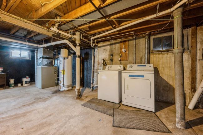Basement featuring water heater, separate washer and dryer, and heating unit | Image 14