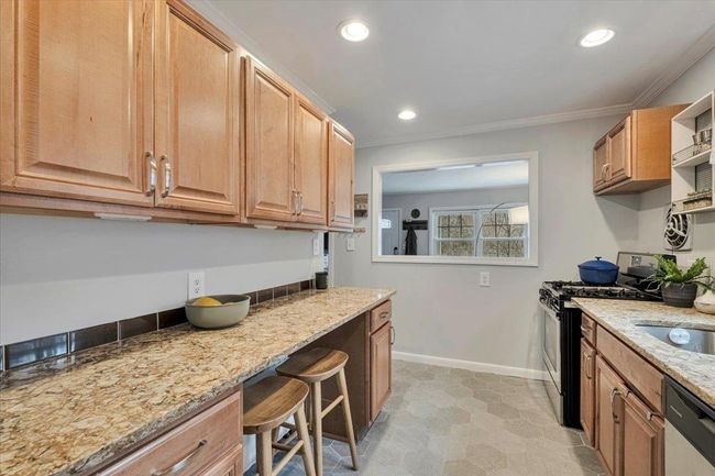 Kitchen featuring recessed lighting, stainless steel range with gas cooktop, baseboards, dishwasher, and light stone countertops | Image 5