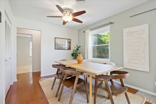 Dining area featuring ceiling fan, baseboards, a healthy amount of sunlight, and wood finished floors | Image 11