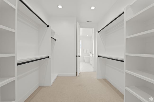 Walk in closet with light carpet | Image 47