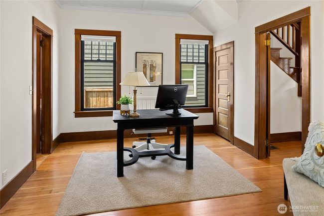 This room is at the heart of the main floor. It can be used as an office or a main floor bedroom. There is a 3/4 bath accessible via the door to the left. | Image 17