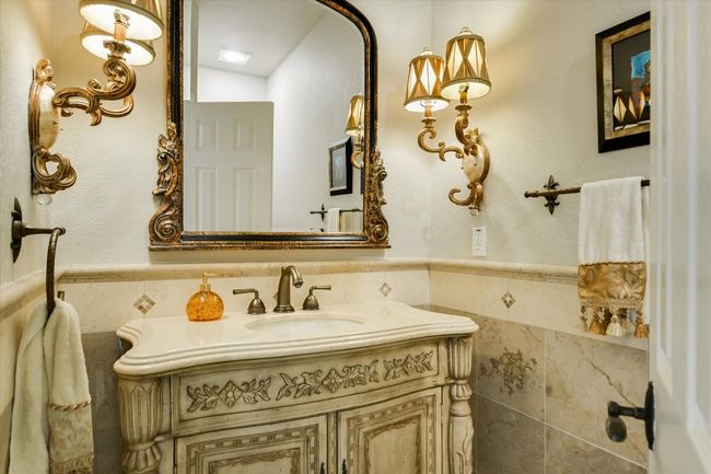 Powder bath with tile walls, wainscoting, and vanity | Image 10