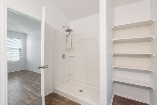 Bathroom with a shower and wood finished floors | Image 14