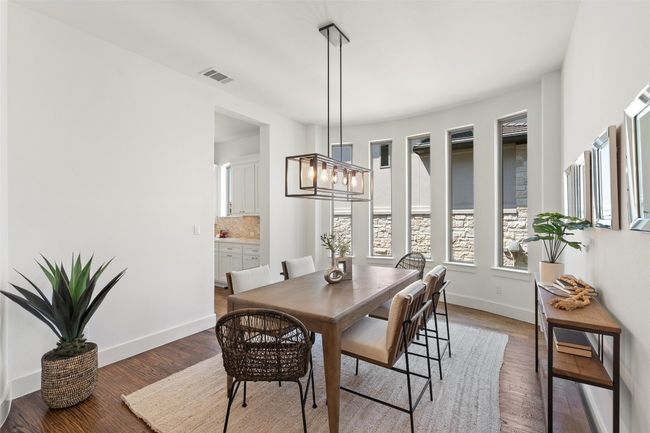 Formal dining space featuring wood finished floors and a chandelier | Image 7