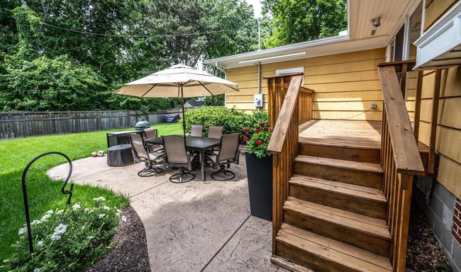 Sliding glass door off of the kitchen leads to the deck & stamped concrete patio. | Image 29