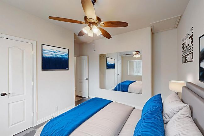 Bedroom with attic access, ceiling fan, and baseboards | Image 5