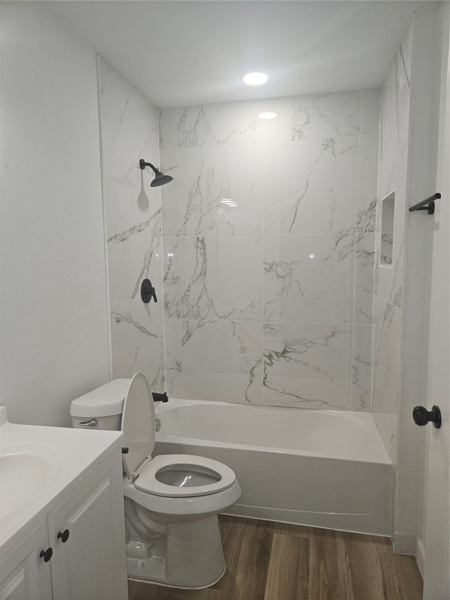 Bathroom with vanity, shower / tub combination, toilet, and wood finished floors | Image 16