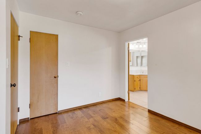 Empty room with baseboards, baseboard heating, light wood-style floors, and a baseboard radiator | Image 19
