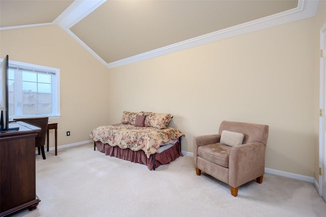 Bedroom with light carpet, lofted ceiling, and crown molding | Image 18