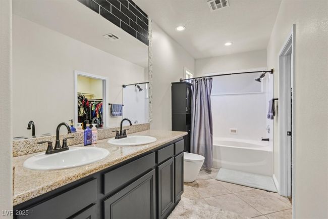 Full bathroom with double vanity, toilet, visible vents, and a sink | Image 18