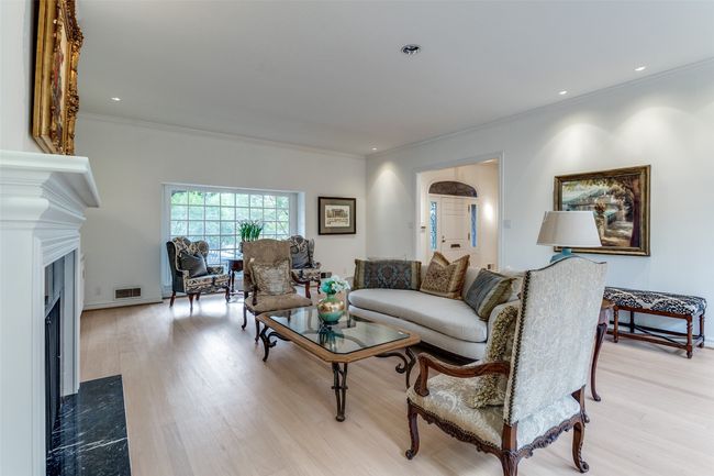 Living room with a premium fireplace, ornamental molding, wood finished floors, and recessed lighting | Image 6