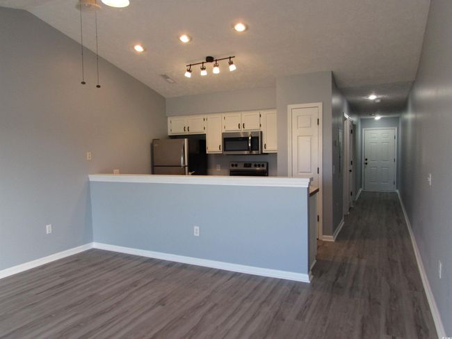 View from the living room towards the kitchen. | Image 31