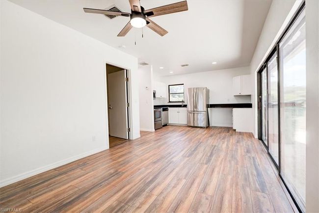 Unfurnished living room with baseboards, recessed lighting, ceiling fan, and light wood-style floors | Image 34