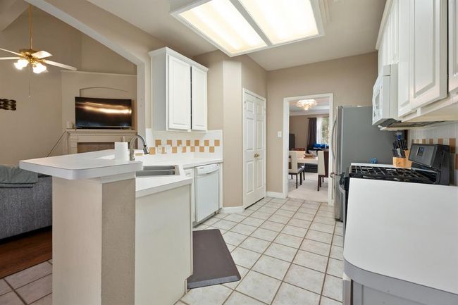 Your kitchen flows into the formal dining room and is open to the living room for great conversation as you cook. | Image 8