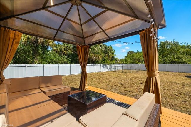 View of patio / terrace featuring an outdoor hangout area, a fenced backyard, and a gazebo | Image 21