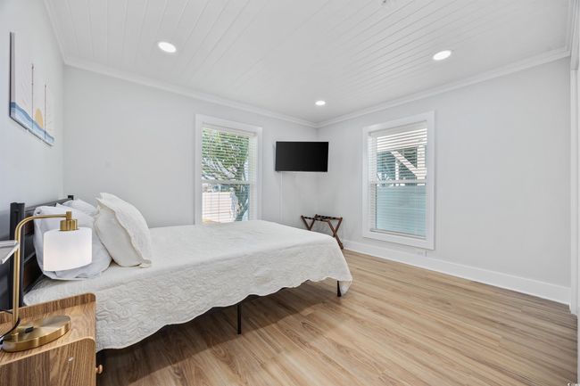 Bedroom with light wood-style flooring, recessed lighting, baseboards, and ornamental molding | Image 10