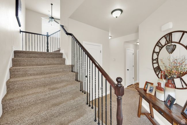 Stairway featuring ceiling fan and carpet | Image 12