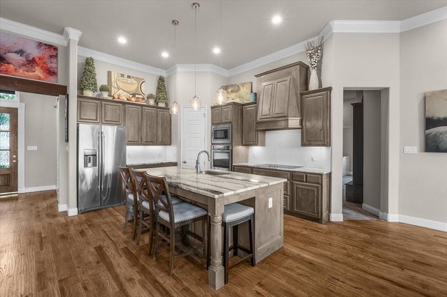 Kitchen featuring large center island with granite countertops | Image 13