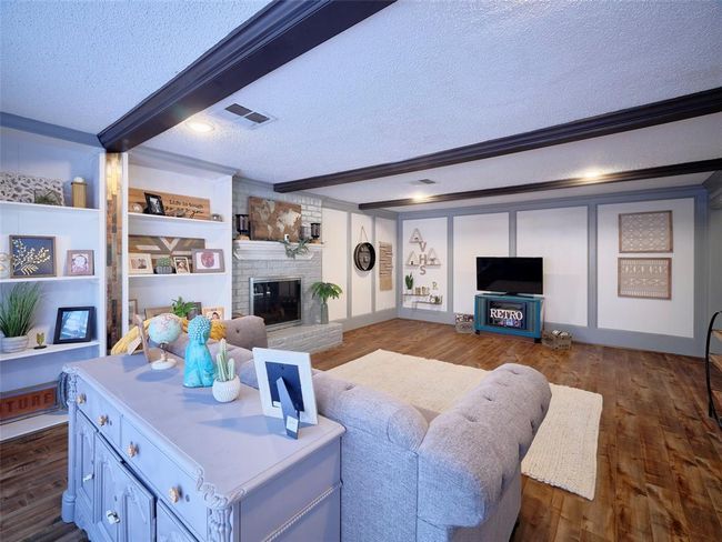 The fireplace and the custom built-ins create a warm and welcoming atmosphere in this room. | Image 7