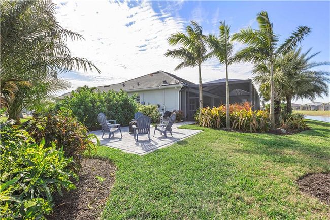 View of yard featuring glass enclosure, a patio, and a water view | Image 28