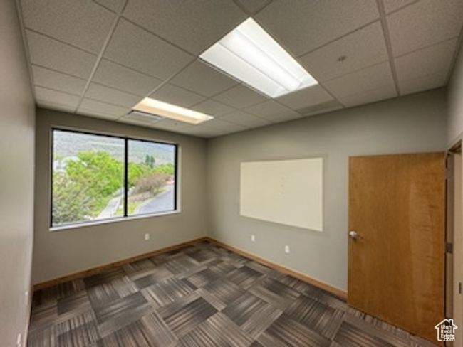 Unfurnished room featuring a drop ceiling and baseboards | Image 23