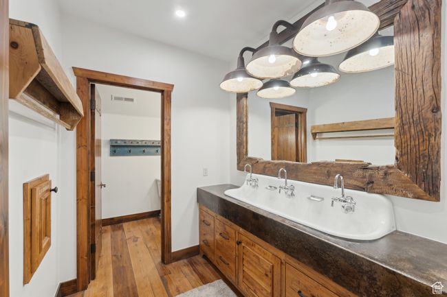 Bathroom featuring wood-type flooring and double vanity | Image 35