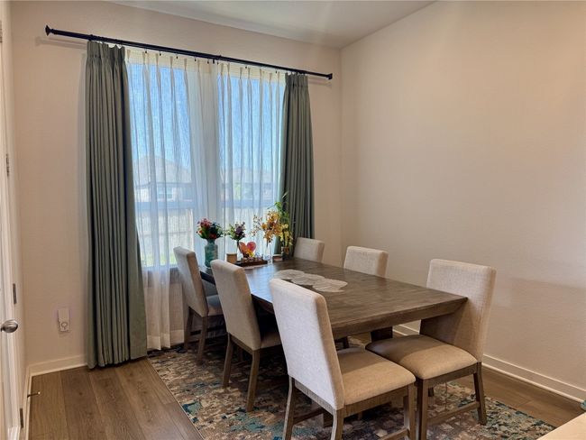Dining room featuring wood finished floors and baseboards | Image 17