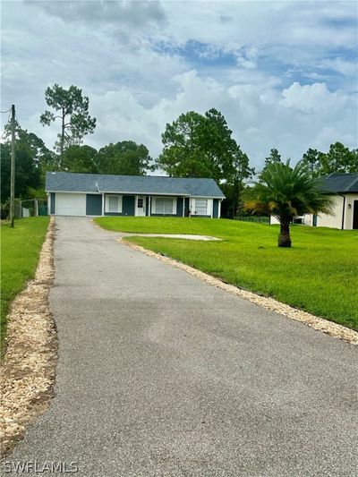 View of front facade featuring a garage and a front lawn | Image 2